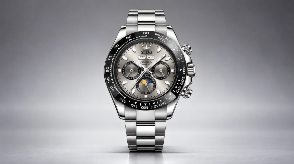 A stainless steel wristwatch with a silver-toned metal bracelet, a black bezel, and a silver dial featuring three subdials and a moonphase indicator.