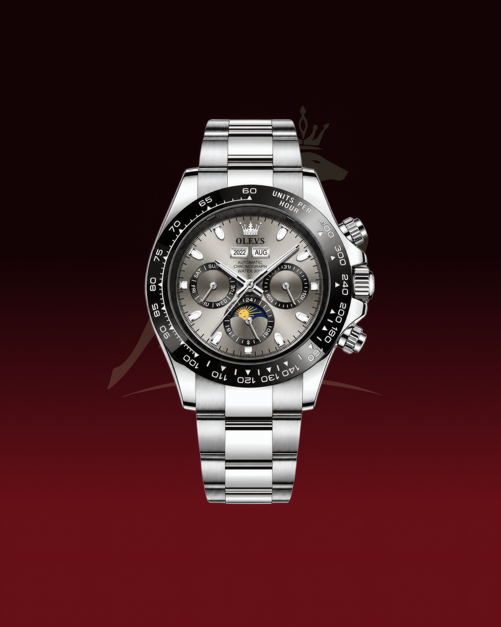 A stainless steel wristwatch with a silver-tone metal bracelet, a black bezel, and a gray dial featuring chronograph subdials and a moonphase indicator, shown against a dark red gradient background.