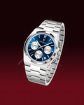 A silver stainless steel wristwatch with a blue dial and three subdials, shown floating against a dark red gradient background.
